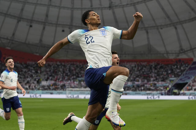 129112216_web1_129112216-95ef68f2759e42c082c833a366f071d9
Englands Jude Bellingham celebrates after scoring his sides opening goal during the World Cup group B soccer match between England and Iran at the Khalifa International Stadium in Doha, Qatar, Monday, Nov. 21, 2022. (AP Photo/Alessandra Tarantino)
