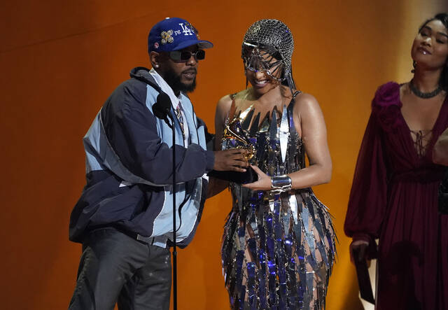 129333092_web1_AP23037094291701
Cardi B, right, presents the award for best rap album to Kendrick Lamar for Mr. Morale & The Big Steppers at the 65th annual Grammy Awards on Sunday in Los Angeles.
AP photo