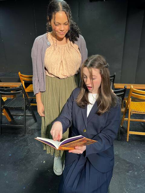 Matilda and Ms. Honey Act Out Theater Group Taylor Ms. Honey, played by Maddan Bennett of Throop, looks on as Matilda, played by Chloe Joyce of Scranton, reads a book. Zoey Schlittler of Dunmore also plays the title role in Act Out Theatre Group’s production of Matilda.
