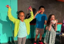 
			
				                                Whether it’s playing with toys or eating candy, the students in Miss Nelson’s class are always doing something other than their schoolwork. From left: Elena Muñoz, Asbin Rai and Sophia Powell.
                                 Photo Credit — Submitted by Act Out Theatre Group

			
		