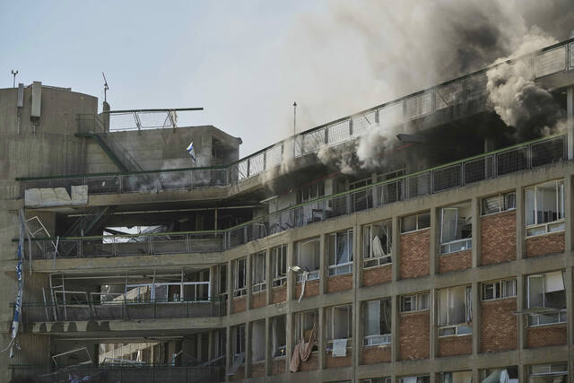 131594537_web1_131594537-e6228d371b3c4f0a91b38f79a5232fe9
Smokes raises from a building of the Soroka hospital complex after it was hit by a missile fired from Iran in Beersheba, Israel, on Thursday.
AP Photo