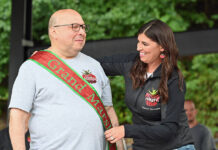 
			
				                                Pittston Tomato Festival committee member Sarah Donahue Cianfichi places the sash over the 2025 Grand Marshal, Ben Tielle. 
                                 Tony Callaio | For Times Leader

			
		