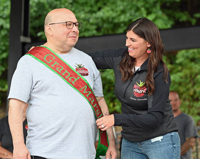 131731795_web1_2025-Pittston-Tomato-Fest-Nite-2
Pittston Tomato Festival committee member Sarah Donahue Cianfichi places the sash over the 2025 Grand Marshal, Ben Tielle.
Tony Callaio | For Times Leader