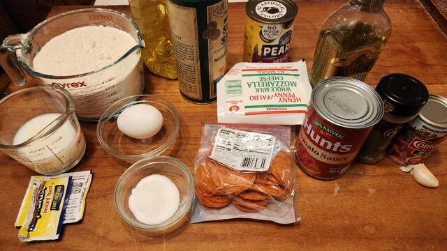 <p>The ingredients for two smaller, or one large, mummy stromboli, but you can keep it much simpler by using a pre-made dough from the store and a jar of pizza or spaghetti sauce instead of making both yourself.</p>
                                 <p>Mark Guydish | for Times Leader</p>