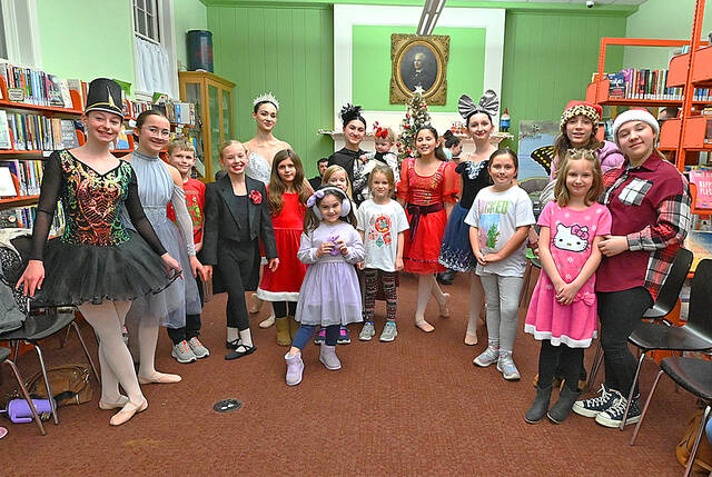 <p>Members of the Dance Theater of Wilkes-Barre posed for photos with some members of their audience at the West Pittston Library on Wednesday at the completion of the troupe’s preview of ‘The Nutcracker Spectacular.’</p>
<p>Tony Callaio | For Times Leader</p>