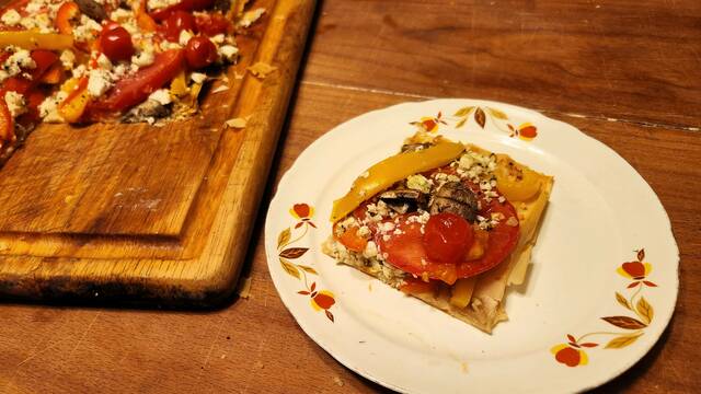 <p>A piece of fresh tomato and feta pizza on a phyllo crust.</p>
<p>Mark Guydish | for Times Leader</p>